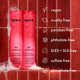 Close-up of shampoo and conditioner bottles with icons and text listing: vegan, cruelty-free, paraben-free, phthalate-free, SLES + SLS-free, sulfate-free, phosphate-free.